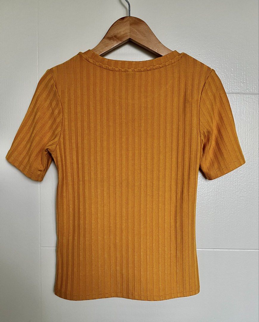Mustard Ribbed Knit Top (Category: Blouses) located in Pasig City. Submitted by jsyrgt (Listing ID 1466427412, Image 2). Description: Condition: 8/10 Has a minor snag at the back (encircled in the last photo). Fit: Fitted, casual everyday basic with a round neckline Styling: Looks perfect with high-waisted denim Color: Mustard Yellow MOP: MariBank QR RFS: wardrobe update *Actual color may vary slightly due to lighting and screen settings.