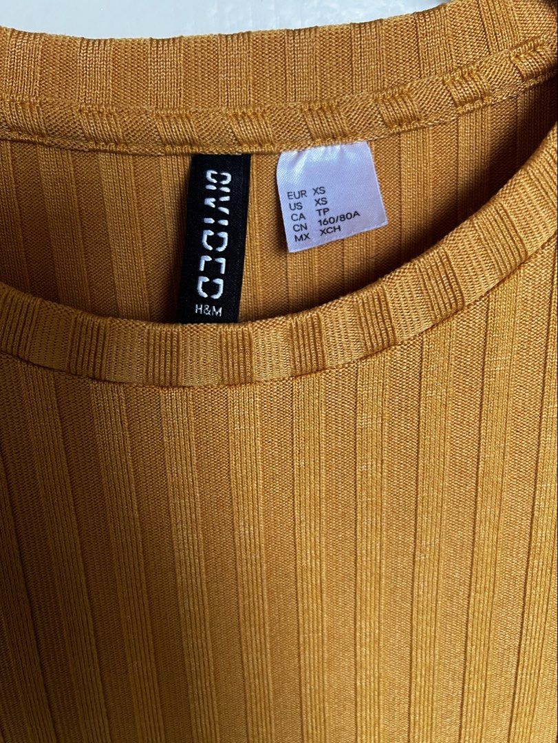 Mustard Ribbed Knit Top (Category: Blouses) located in Pasig City. Submitted by jsyrgt (Listing ID 1466427412, Image 3). Description: Condition: 8/10 Has a minor snag at the back (encircled in the last photo). Fit: Fitted, casual everyday basic with a round neckline Styling: Looks perfect with high-waisted denim Color: Mustard Yellow MOP: MariBank QR RFS: wardrobe update *Actual color may vary slightly due to lighting and screen settings.