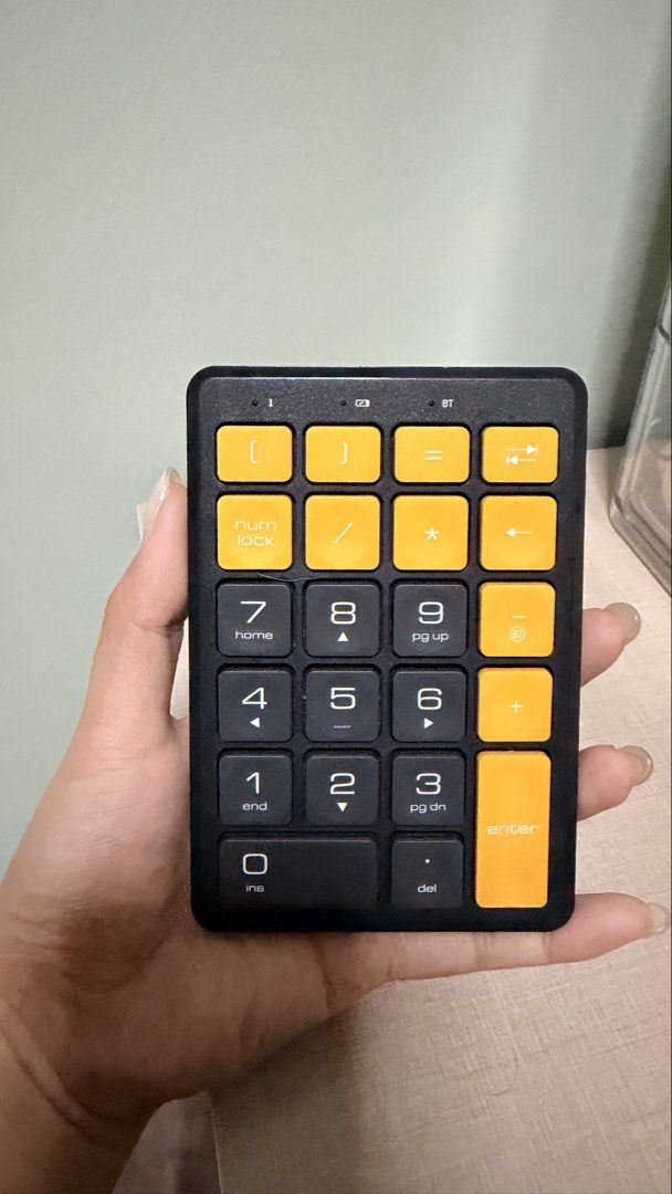 N58 Bluetooth Digital Keypad Brown Sugar (Category: Computer Keyboard) located in Cebu City. Submitted by eynjlin (Listing ID 1466486635, Image 2). Description: - Model: N58 Bluetooth Digital Keypad - Color: Brown Sugar with custom yellow and dark grey keycaps - Connectivity: Wireless Bluetooth - Power: 3.7V rated voltage, 2.0mA rated current - Design: Compact and portable, ideal for laptops without a built-in numeric keypad.