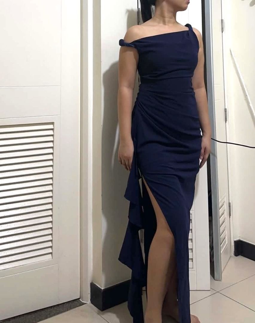 Navy Blue One-Shoulder Ruffle Maxi Dress (Category: Dresses) located in Mandaluyong City. Submitted by lovedbyjaaaam (Listing ID 1466362810, Image 1). Description: - Color: Navy blue / Midnight Blue - Style: One-shoulder, floor-length evening dress - Design: Fitted bodice with diagonal ruching and a high side slit with cascading ruffles - Condition: Brand New, sinukat lang pero di nagamit -Premium, makapal tela - Ideal for: Weddings, galas, and f