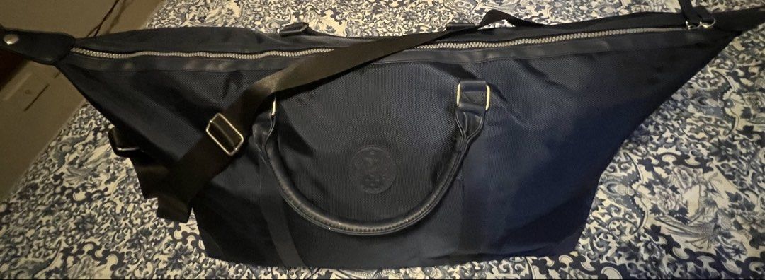 Navy Blue Travel Duffle Bag with Shoulder Strap (Category: Sling Bags) located in Pasig City. Submitted by edgarlou (Listing ID 1466475700, Image 1). Description: - Color: Navy blue with dark trim details - Material: Durable woven fabric construction - Storage: Deep interior space ideal for travel, gym, or weekend getaways - Closure: Full-width top zipper closure - Portability: Dual carry handles and an adjustable black shoulder strap with hardwa