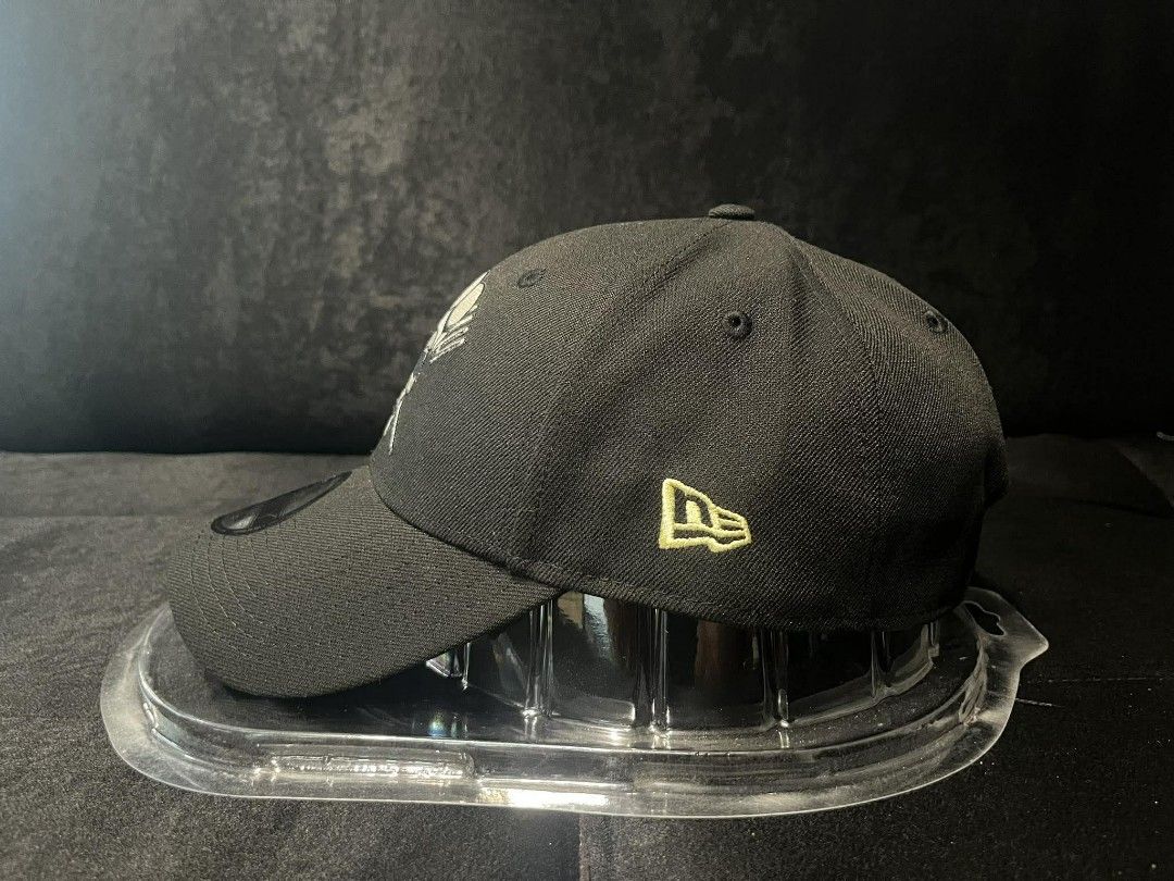 New Era 9FORTY One Piece Skull Chef Cap (Category: Caps & Hats) located in Manila. Submitted by monkeydelevi (Listing ID 1466424121, Image 3). Description: New Era 9FORTY adjustable cap. Black fabric featuring a One Piece chef skull logo embroidered on the front. Yellow One Piece lettering along the side. Knife embroidery detail on the back. Blue and white striped lining inside. Standard strapback closure with metal buckle. Original tag still att