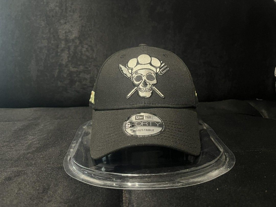 New Era 9FORTY One Piece Skull Chef Cap (Category: Caps & Hats) located in Manila. Submitted by monkeydelevi (Listing ID 1466424121, Image 1). Description: New Era 9FORTY adjustable cap. Black fabric featuring a One Piece chef skull logo embroidered on the front. Yellow One Piece lettering along the side. Knife embroidery detail on the back. Blue and white striped lining inside. Standard strapback closure with metal buckle. Original tag still att