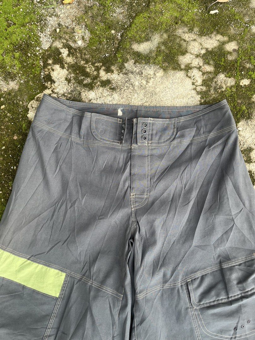 Nike ACG Cargo Boardshorts Grey Green (Category: Shorts) located in San Isidro, Leyte. Submitted by tigerxdx3580077 (Listing ID 1466414072, Image 2). Description: - Brand: Nike ACG - Waistline: 31to34 - Length: 22 - Color: Dark grey with muted green contrast panels - Features: Multiple utility pockets on the right leg with drainage grommets - Branding: Printed All Conditions Gear logo on the lower back leg - Closure: Button fly - Ideal for: Outdo