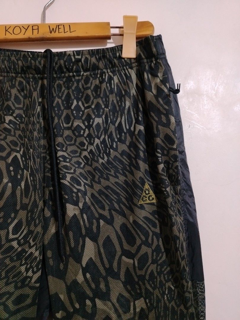 Nike ACG Dri-Fit Leopard Print Pants (Category: Joggers) located in Cavite. Submitted by koyawell.ph (Listing ID 1466408534, Image 3). Description: - Brand: Nike ACG - Size large - 39 length - Style: Track pants with olive green and black solid panels - Design: All-over leopard print mesh material - Performance: Dri-Fit technology to keep you dry and comfortable - Fit: Elastic waistband with adjustable drawstring, Size Large - Origin: Made in Vie