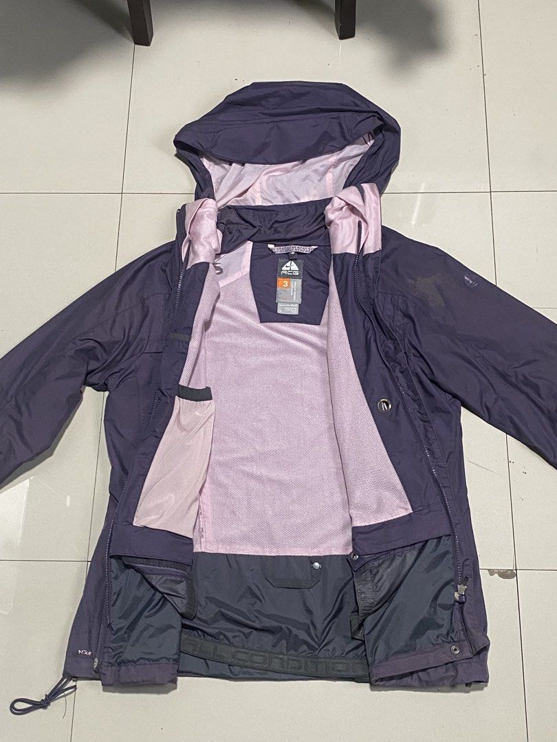 Nike ACG Triple Layer Hooded Jacket Purple Size L (Category: Coats, Jackets and Outerwear) located in Baguio. Submitted by yunothewizardking (Listing ID 1466440637, Image 2). Description: - Brand: Nike ACG - Color: Purple - Size: L (165/88A) - Material: Nylon outer shell with polyester upper lining - Closure: Full zip front with attached hood - Fit/Adjustability: Adjustable drawstrings at waist and hem - Features: Inner elastic powder skirt, mult