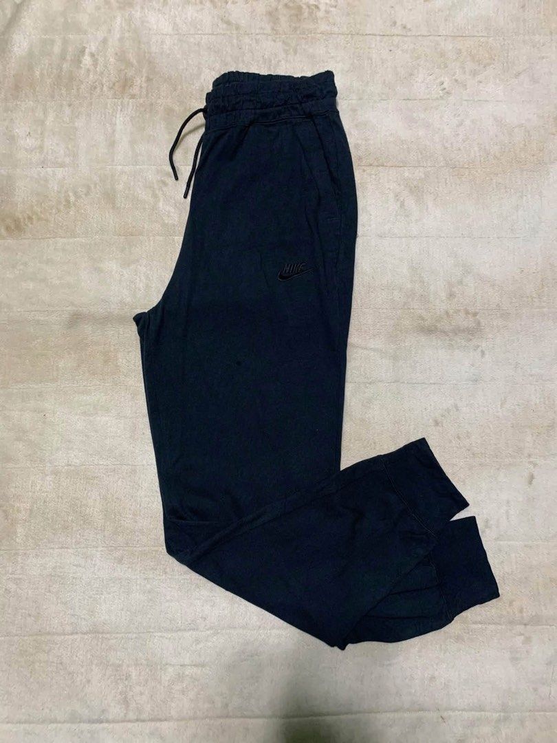 Nike Black Jogger Pants (Category: Joggers) located in Cabuyao City. Submitted by laguna_thrifter (Listing ID 1466369814, Image 2). Description: - Brand: Nike - Color: Black - Size: Medium (Made in China) - Fit & Comfort: Elastic waistband with adjustable drawstring and ribbed ankle cuffs - Details: Embroidered small Nike swoosh logo on the left thigh + functional back pockets - Best for: Daily workouts, gym sessions, or casual lounging.