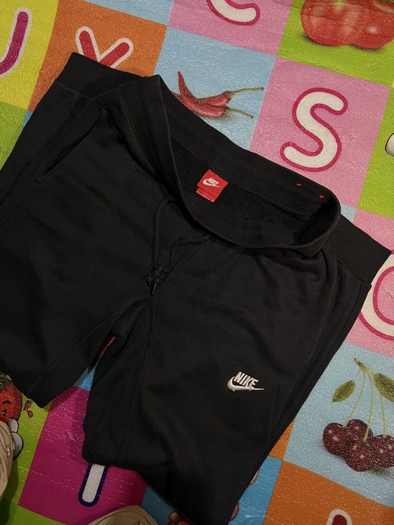Nike Black Sweatpants Joggers Size XL (Category: Joggers) located in Manila. Submitted by kayee.3 (Listing ID 1466495872, Image 2). Description: - Brand: Nike - Color: Black with white drawstrings and stacked leg logos - Size: XL - Material: Comfortable and breathable cotton blend - Features: Elastic waistband, ribbed cuffs, and a secure zippered side pocket - Condition: Great for workouts, running errands, or lounging at home - Shipping: Fast sh