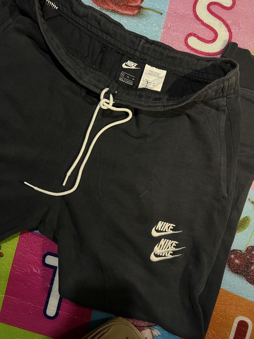 Nike Black Sweatpants Joggers Size XL (Category: Joggers) located in Manila. Submitted by kayee.3 (Listing ID 1466495872, Image 1). Description: - Brand: Nike - Color: Black with white drawstrings and stacked leg logos - Size: XL - Material: Comfortable and breathable cotton blend - Features: Elastic waistband, ribbed cuffs, and a secure zippered side pocket - Condition: Great for workouts, running errands, or lounging at home - Shipping: Fast sh