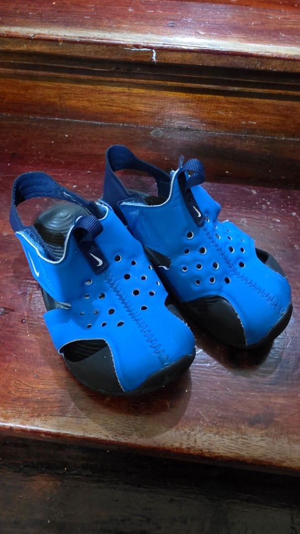 Nike Blue Kids Sandals (Category: Babies & Kids Fashion) located in Valenzuela. Submitted by bella_onez (Listing ID 1466444649, Image 1). Description: - Brand/Model: Nike Kids Sandals - Color: Blue and black - Design: Slip-on with a secure back strap - Comfort & Breathability: Perforated upper material - Sole: Textured footbed and wave-patterned rubber for good grip - Best for: Water activities and casual everyday wear.