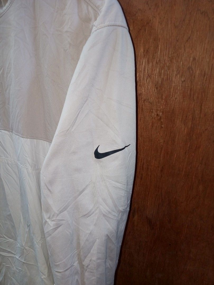 Nike BV0388-221 Half Zip Jacket Size XL (Category: Coats, Jackets and Outerwear) located in Manila. Submitted by jeancharis67207 (Listing ID 1466524304, Image 2). Description: Nike half-zip jacket in a two-tone cream and white colorway. Stand-up collar with a black front zipper. Long sleeves with the black Nike Swoosh logo printed near the cuff. Front pockets with zippers on both sides. Size XL label inside. Product code BV0388-221. Clean fabric 