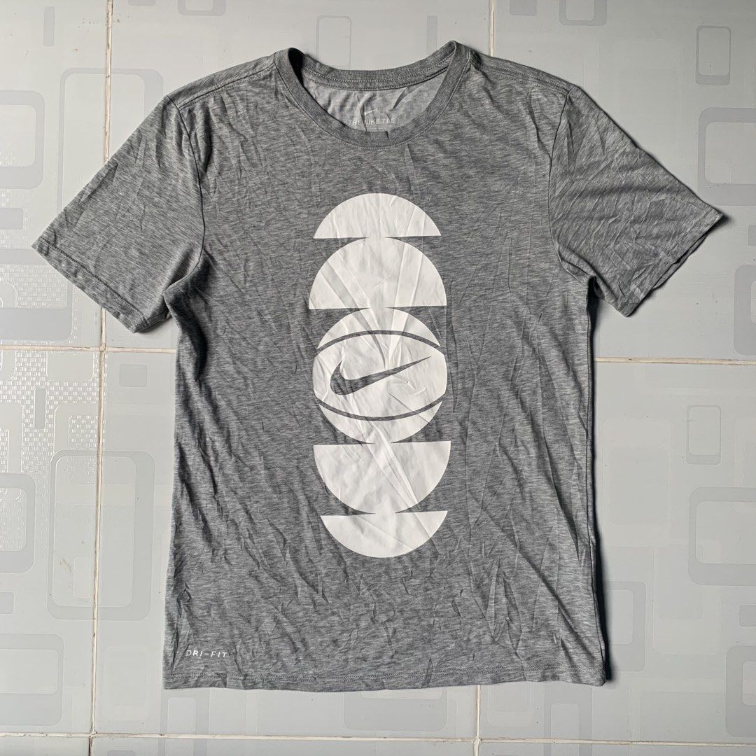 Nike Dri-Fit Grey Graphic Tee Size S (Category: Tshirts & Polo Shirts ) located in Daraga. Submitted by vinteesfnds (Listing ID 1466390901, Image 1). Description: - Brand: Nike Dri-Fit - Color: Grey with white abstract basketball graphic - Size: S Men - Size: M women - Material: 58% cotton, 42% polyester blend - Condition: Clean, with light wrinkles from folding - Style: Short sleeves, crew neck.