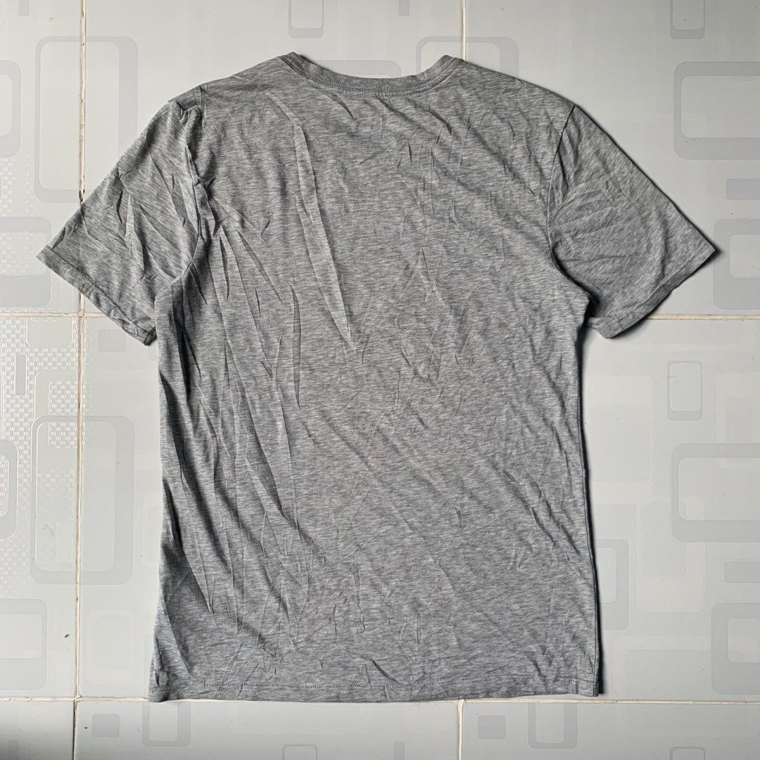 Nike Dri-Fit Grey Graphic Tee Size S (Category: Tshirts & Polo Shirts ) located in Daraga. Submitted by vinteesfnds (Listing ID 1466390901, Image 2). Description: - Brand: Nike Dri-Fit - Color: Grey with white abstract basketball graphic - Size: S Men - Size: M women - Material: 58% cotton, 42% polyester blend - Condition: Clean, with light wrinkles from folding - Style: Short sleeves, crew neck.