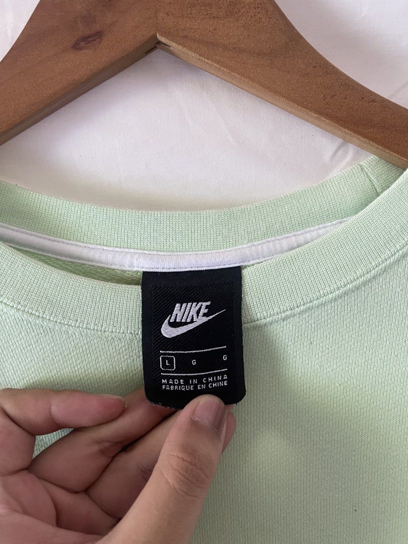 Nike Green Sweatshirt Size L (Category: Coats, Jackets and Outerwear) located in Manila. Submitted by noahcastilljos363 (Listing ID 1466348089, Image 2). Description: - Brand: Nike - Style: Crewneck sweatshirt - Color: Mint green - Size: Large (Oversized fit with drop shoulders) - Material: 100% cotton French terry fabric - Details: Large graphic patch near bottom hem, ribbed collar, cuffs, and hem - Condition: Clean inside and out.