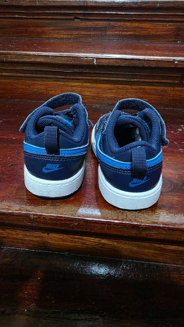 Nike Navy Blue Toddler Sneakers (Category: Babies & Kids Fashion) located in Valenzuela. Submitted by bella_onez (Listing ID 1466445573, Image 3). Description: - Dark blue toddler trainers with bright blue swoosh logos - White rubber soles with good grip patterns for safety - Easy velcro strap over elastic laces for quick wear - Convenient pull tabs at the back heels - Clean condition overall.