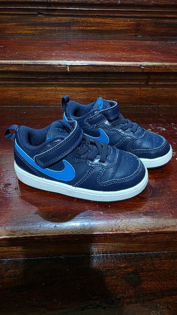 Nike Navy Blue Toddler Sneakers (Category: Babies & Kids Fashion) located in Valenzuela. Submitted by bella_onez (Listing ID 1466445573, Image 2). Description: - Dark blue toddler trainers with bright blue swoosh logos - White rubber soles with good grip patterns for safety - Easy velcro strap over elastic laces for quick wear - Convenient pull tabs at the back heels - Clean condition overall.