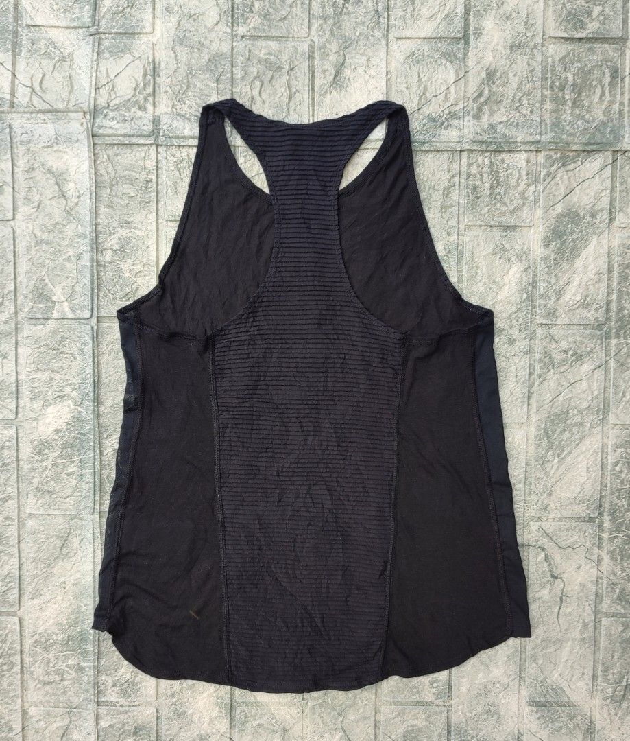 Nike Pro AeroAdapt Women's Training Tank Top (Category: Activewear) located in Bayambang. Submitted by mon10192816 (Listing ID 1466466949, Image 2). Description: - Width 15¾ - Length 23¼ - Brand: Nike - Model: AeroAdapt Training Tank Top (Style CU5717-010) - Color: Black - Size: Large (L) - Material: Body (75% polyester, 13% cotton, 12% rayon), Panels (81% polyester, 19% nylon) - Features: Racerback design, ribbed back panel, and mesh side panels