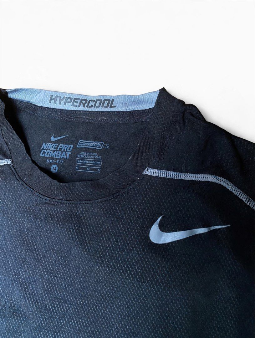 Nike Pro Combat Hypercool Compression Shirt (Category: Activewear) located in Las Pinas. Submitted by john.ross.sayoc.30-82096 (Listing ID 1466391448, Image 3). Description: - Brand: Nike Pro Combat Hypercool - Color: Black with light blue collar lining - Size: Medium (snug athletic fit) - Technology: Dri-FIT moisture-wicking fabric - Ventilation: Breathable mesh panels on front chest and back - Details: Small woven Nike Pro logo patch near botto