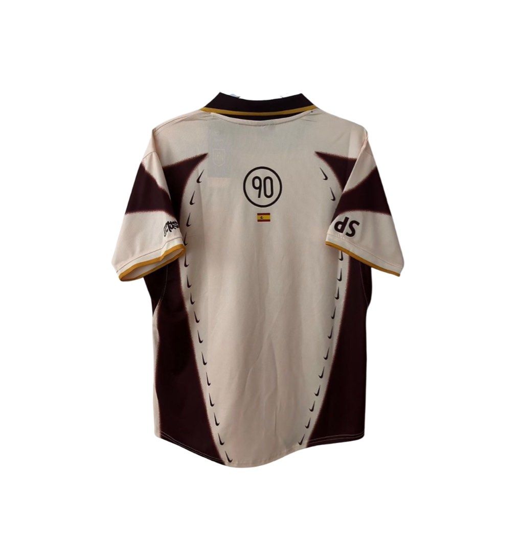 Nike T90 x Cactus Jack jersey (spain) (Category: Activewear) located in Caloocan City. Submitted by dontii (Listing ID 1466446955, Image 1). Description: Dimes: 22x27 Reps Nike Total 90 Spain football jersey. Off-white base with maroon side panels, black swoosh outlines running down the ribs. Spanish flag below the number 90 circle graphic on the back. Collared neckline with gold and dark brown trim. Short sleeves with matching trim. Tag still at
