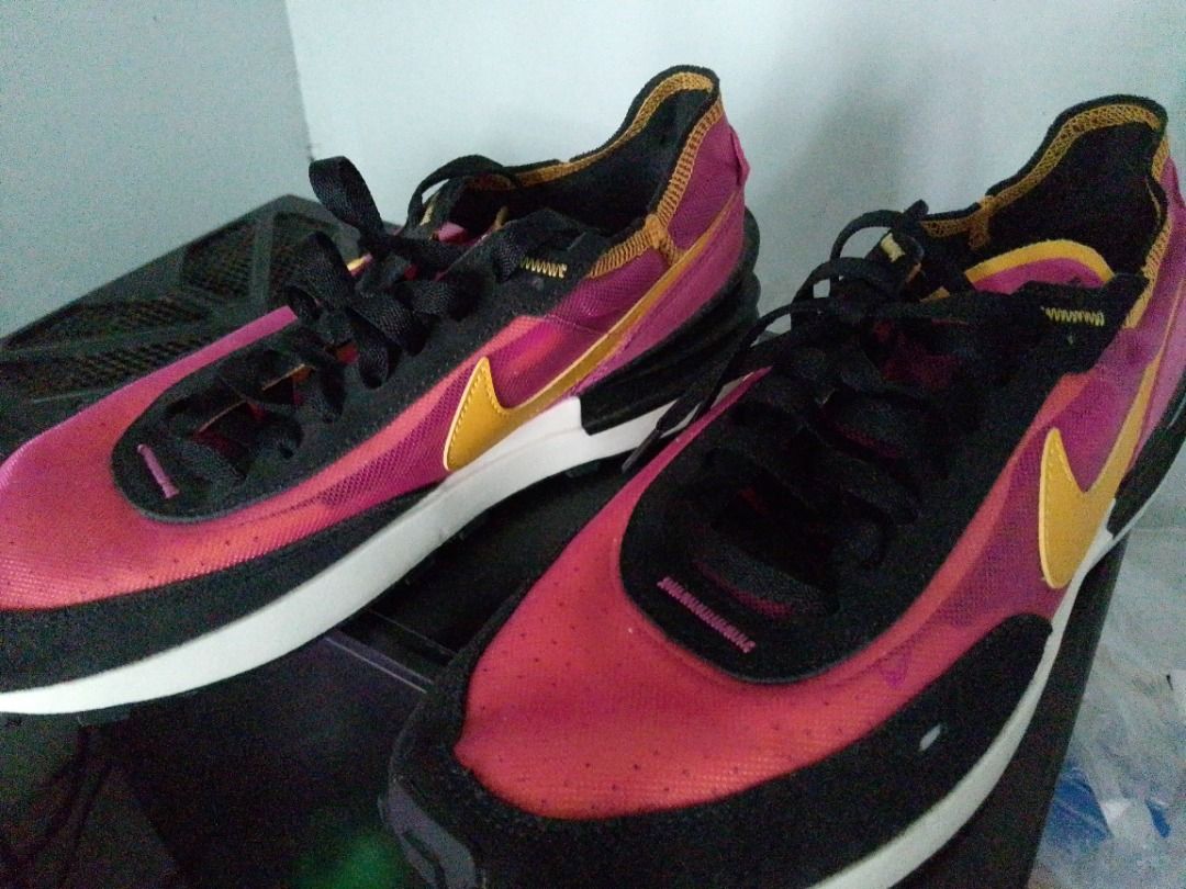 Nike Waffle One Active Fuchsia (Category: Sneakers) located in Pavia. Submitted by ilawod_shop (Listing ID 1466364752, Image 2). Description: - Brand: Nike Waffle One - Colorway: Vibrant pink, black, and yellow with a bold yellow swoosh - Materials: Translucent mesh upper with premium suede overlays - Sole: Dual-stacked wedge midsole and classic waffle rubber outsole - Details: Black laces and contrast collar trim - Condition: Clean uppers and mi