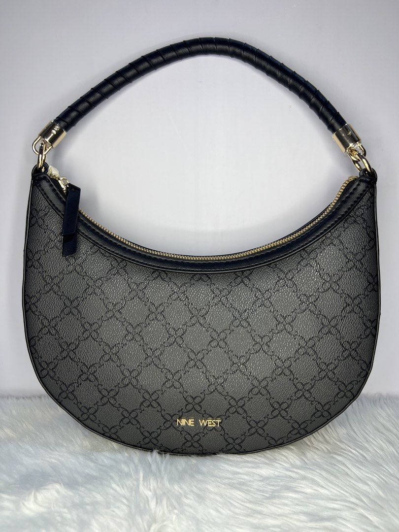 Nine West Black Pattern Crescent /hoboShoulder Bag (Category: Shoulder Bags) located in Quezon City. Submitted by gigisantos (Listing ID 1466504341, Image 1). Description: - Brand: Nine West - Style: Black crescent shoulder bag with structured faux leather - Design: All-over monogram pattern with chic gold hardware accents - Closure: Secure top zip closure - Straps: Single rolled shoulder strap with metal clasps - Interior: Includes a handy zippe