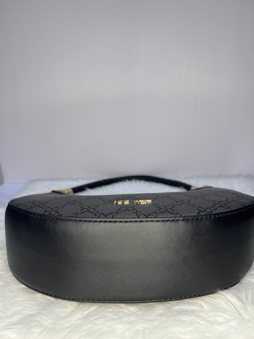 Nine West Black Pattern Crescent /hoboShoulder Bag (Category: Shoulder Bags) located in Quezon City. Submitted by gigisantos (Listing ID 1466504341, Image 3). Description: - Brand: Nine West - Style: Black crescent shoulder bag with structured faux leather - Design: All-over monogram pattern with chic gold hardware accents - Closure: Secure top zip closure - Straps: Single rolled shoulder strap with metal clasps - Interior: Includes a handy zippe