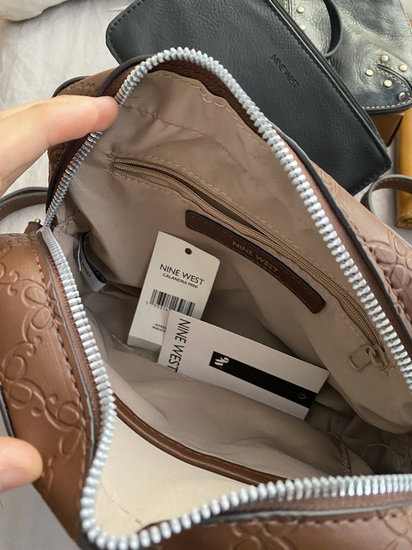 Nine West Brown Embossed Monogram Crossbody Bag (Category: Cross-body Bags) located in Manila. Submitted by mpt99876 (Listing ID 1466521266, Image 3). Description: - Authentic Nine West crossbody bag in a stylish brown hue. - Features a sophisticated all-over embossed monogram pattern. - Secure zip-top closure to keep your belongings safe. - Interior includes a convenient zip pocket and a slip pocket for organization. - Adjustable strap for comfo