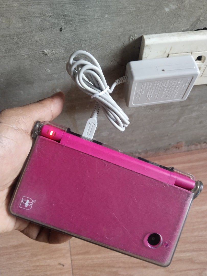 Nintendo DSi Pink with AC Adapter and Box (Category: Nintendo) located in Manila. Submitted by megazordbuilderhunter (Listing ID 1466378151, Image 3). Description: - Pink Nintendo DSi handheld console bundle - Comes with original box and AC adapter charging cable - Pre-installed clear protective case included - Dual screens, D-pad, and face buttons are all physically intact - IMPORTANT: Bottom screen displays an error message upon bootup (sold as