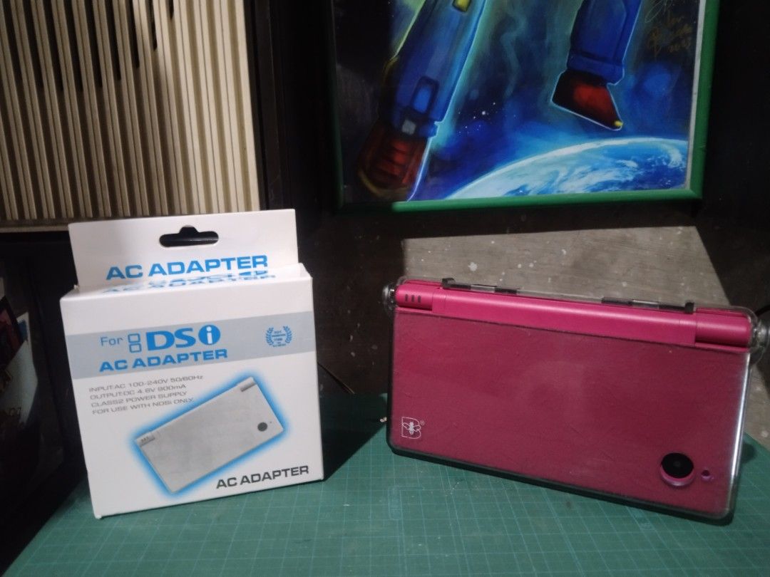 Nintendo DSi Pink with AC Adapter and Box (Category: Nintendo) located in Manila. Submitted by megazordbuilderhunter (Listing ID 1466378151, Image 1). Description: - Pink Nintendo DSi handheld console bundle - Comes with original box and AC adapter charging cable - Pre-installed clear protective case included - Dual screens, D-pad, and face buttons are all physically intact - IMPORTANT: Bottom screen displays an error message upon bootup (sold as