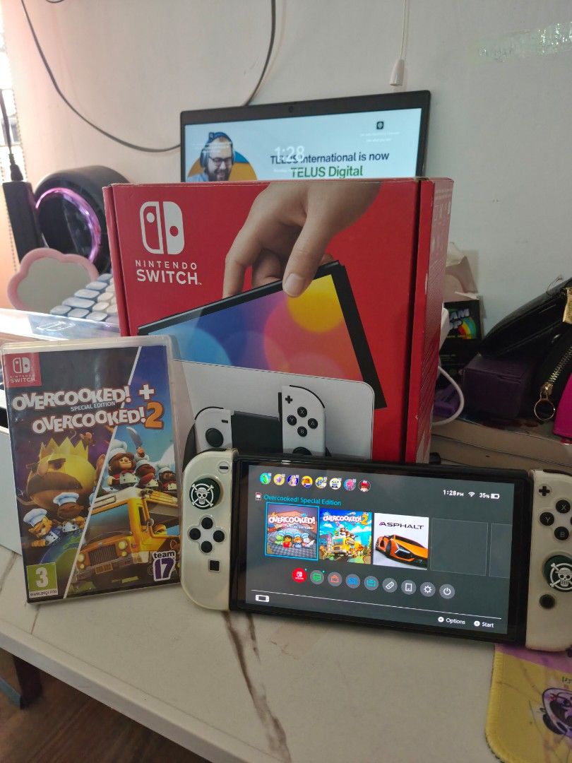 Nintendo Switch OLED Model White with Overcooked 2 (Category: Nintendo) located in Manila. Submitted by marksoro4722768 (Listing ID 1466494043, Image 1). Description: - Nintendo Switch OLED (White) in excellent, fully working condition - Includes original box and dock - Comes with cute One Piece thumb grips installed - Includes physical game cartridge: Overcooked! All You Can Eat - RFS: Decluttering, ready for a new owner!.