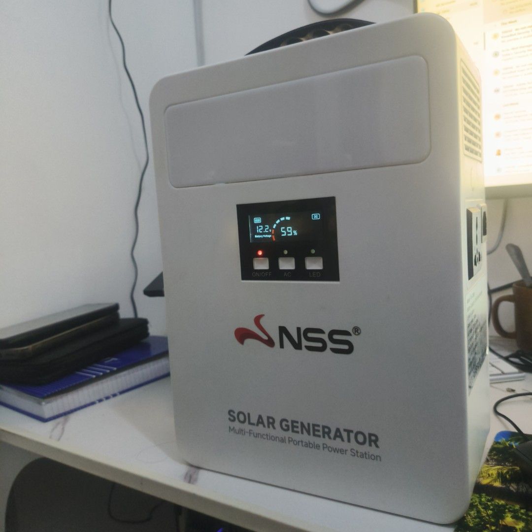 NSS Solar Generator Multi-Functional Portable Power Station (Category: Electrical, Adaptors & Sockets) located in Caloocan City. Submitted by leoregidor11 (Listing ID 1466433158, Image 1). Description: - Brand: NSS Solar Generator Unit - Color: Clean white portable casing with top carrying handle - Display: Digital screen showing 12.2V battery voltage and 59% charge level - Controls: Physical buttons for power, AC, and built-in LED functions - Po