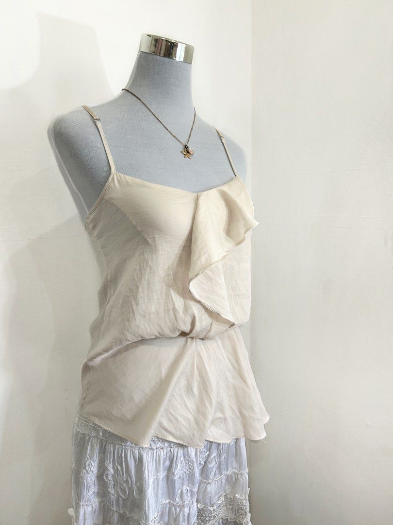 OBAKKI Cream Elegant asymmetrical fluid cascading ruffle down Cami (Category: Sleeveless) located in Quezon City. Submitted by cooroe.mnl (Listing ID 1466521107, Image 3). Description: S-M 10/10 .