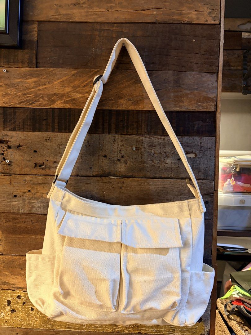 Off-White Canvas Crossbody Bag with Multiple Pockets (Category: Cross-body Bags) located in Quezon City. Submitted by makingroomfinds (Listing ID 1466526532, Image 2). Description: - Color: Off-White (Neutral solid color matches any outfit) - Material: Durable canvas with secure lining - Strap: Adjustable for comfortable wear - Pockets: 2 large front flap pockets, side pockets on both ends, and a back slip pocket - Interior: Includes 1 zippered p
