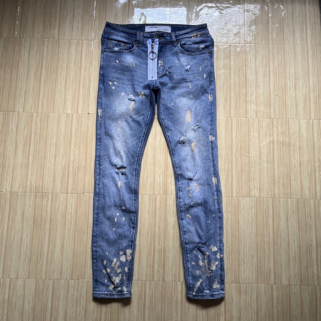 Off-White c/o Virgil Abloh distressed (Category: Jeans) located in Hagonoy. Submitted by ianthrift_ph (Listing ID 1466525296, Image 2). Description: complete tags/authentic 30 to 32 waistline 40 length, 11 thigh, 6.5 hem slim fit, all over splatter paint good condition color rate 9/10 minor flaws .