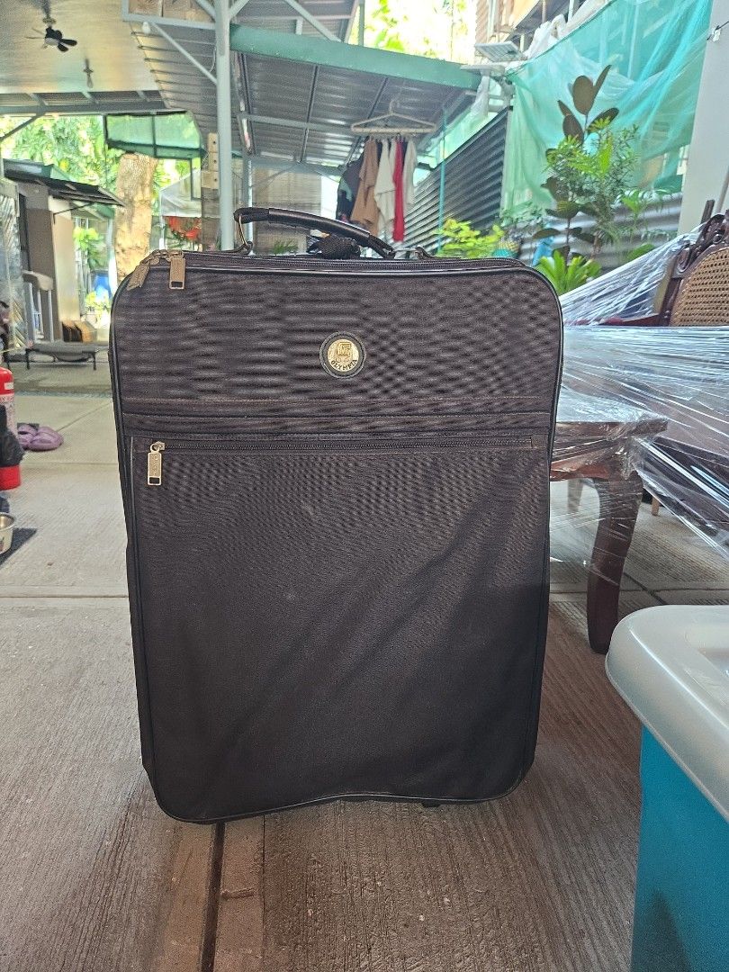 Olympia Black Rolling Suitcase Luggage (Category: Luggage) located in Manila. Submitted by preownedddd (Listing ID 1466344096, Image 1). Description: - Brand: Olympia - Color: Classic black fabric - Mobility: Smooth rolling wheels with a retractable handle - Storage: Multiple exterior zippered pockets for easy access - Durability: Sturdy reinforced corner guards and horizontal support straps - Condition: Clean exterior with minor signs of handlin