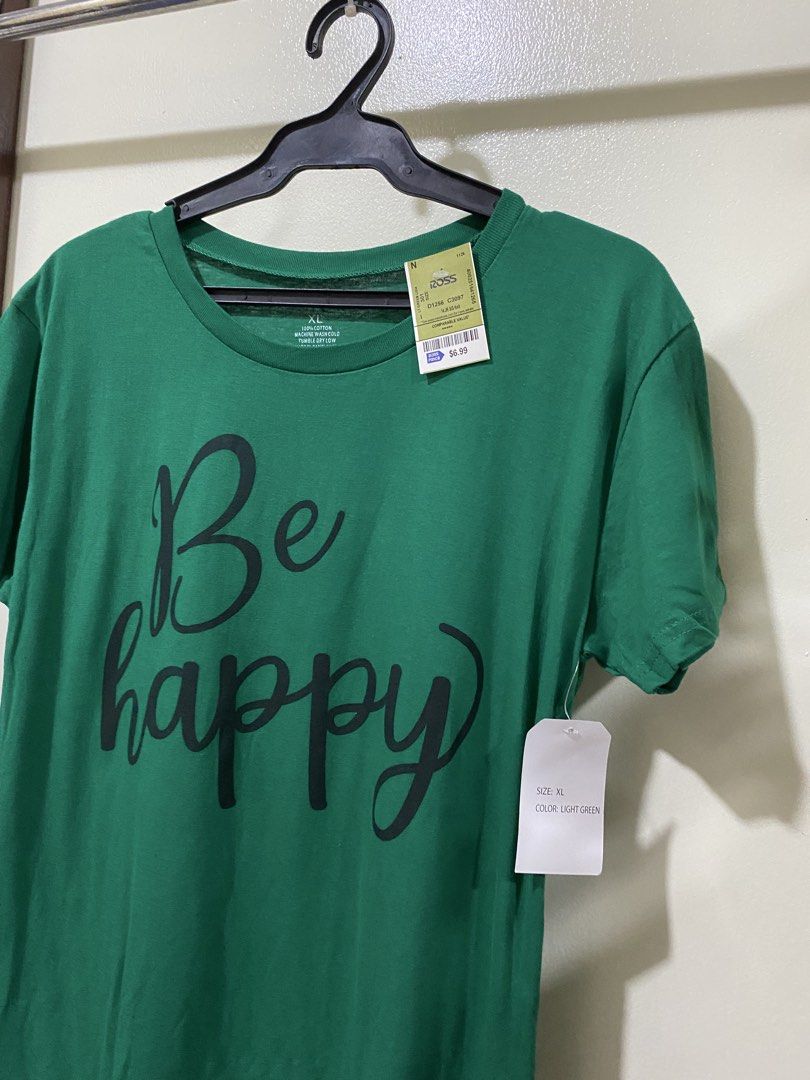 On Fire Be Happy Green Graphic Tee Size XL (Category: Shirts) located in Manila. Submitted by divinemercy_29 (Listing ID 1466464256, Image 3). Description: - Brand: On Fire - Size: Extra Large (XL) - Color: Green - Material: 100% Cotton (machine wash cold, tumble dry low) - Condition: Brand new, unworn with original Ross retail tag ($6.99) - Design: Front reads 'Be happy' in black cursive; back reads 'Do more of what makes YOU HAPPY'.
