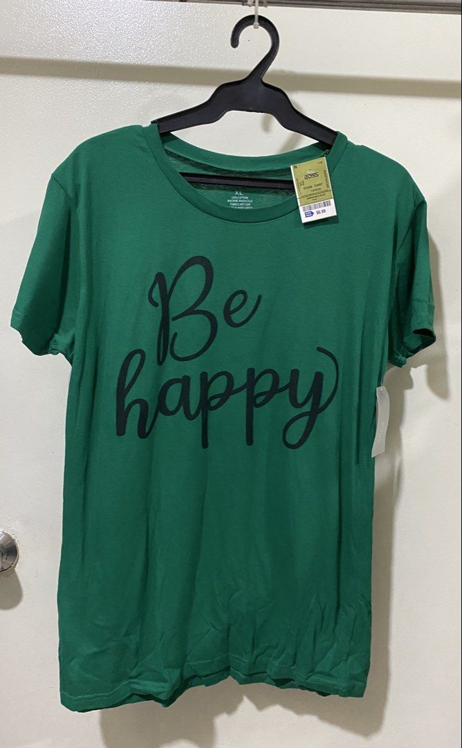 On Fire Be Happy Green Graphic Tee Size XL (Category: Shirts) located in Manila. Submitted by divinemercy_29 (Listing ID 1466464256, Image 1). Description: - Brand: On Fire - Size: Extra Large (XL) - Color: Green - Material: 100% Cotton (machine wash cold, tumble dry low) - Condition: Brand new, unworn with original Ross retail tag ($6.99) - Design: Front reads 'Be happy' in black cursive; back reads 'Do more of what makes YOU HAPPY'.