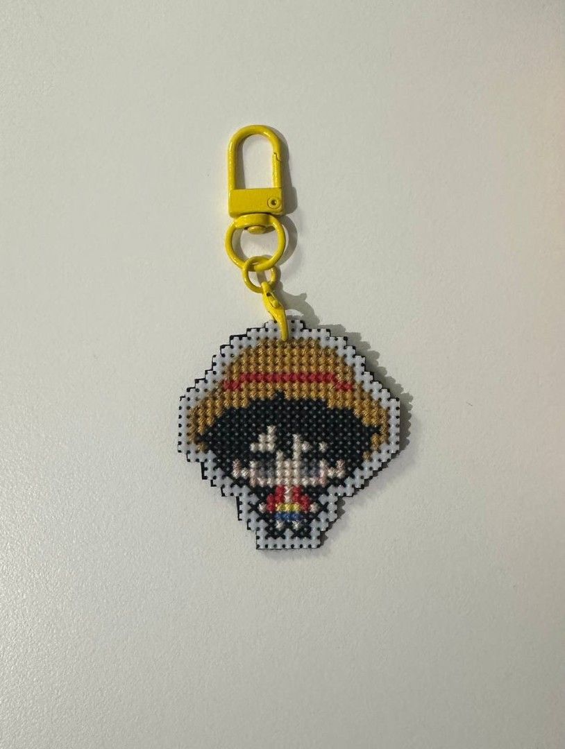 One Piece Luffy Cross Stitch Keychain (Category: Handmade Craft) located in Imus. Submitted by t0t3fairi3 (Listing ID 1466359889, Image 2). Description: Handmade Monkey D. Luffy cross stitch keychain with a sturdy plastic mesh backing and a bright yellow lobster clasp. Perfect for keys, bags, or as a gift for One Piece fans!.