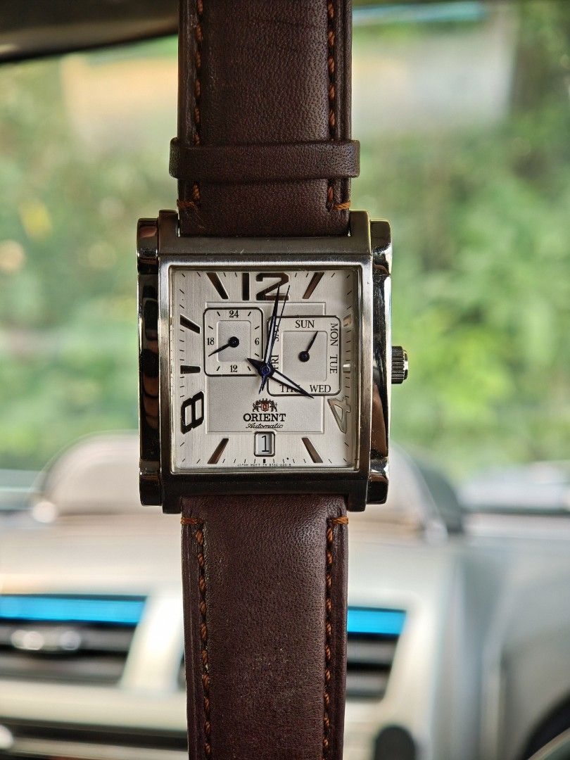 Orient Automatic Rectangular Dial Men's Watch (Category: Watches) located in Kuala Terengganu. Submitted by adibrahman65183 (Listing ID 1466539760, Image 3). Description: Authentic Orient automatic watch with a striking rectangular silver dial, large Arabic numerals, and a dark brown leather strap. Features day, date, and 24-hour sub-dials with 50m water resistance. Note: date needs repair, to be sell as collection.