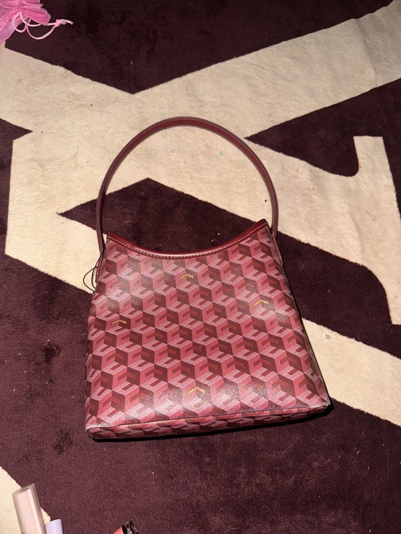 Original Christy Ng Maroon Geometric Pattern Shoulder Bag (Category: Luxury Bags & Wallets) located in Manila. Submitted by saturnina89 (Listing ID 1466447241, Image 3). Description: Christy Ng shoulder bag in maroon with a geometric cube print all over. Single dark red strap on top. Inside has a reddish fabric lining, one zippered pocket on the back wall, and another zipper compartment divider. Gold logo text printed on the exterior and inside z