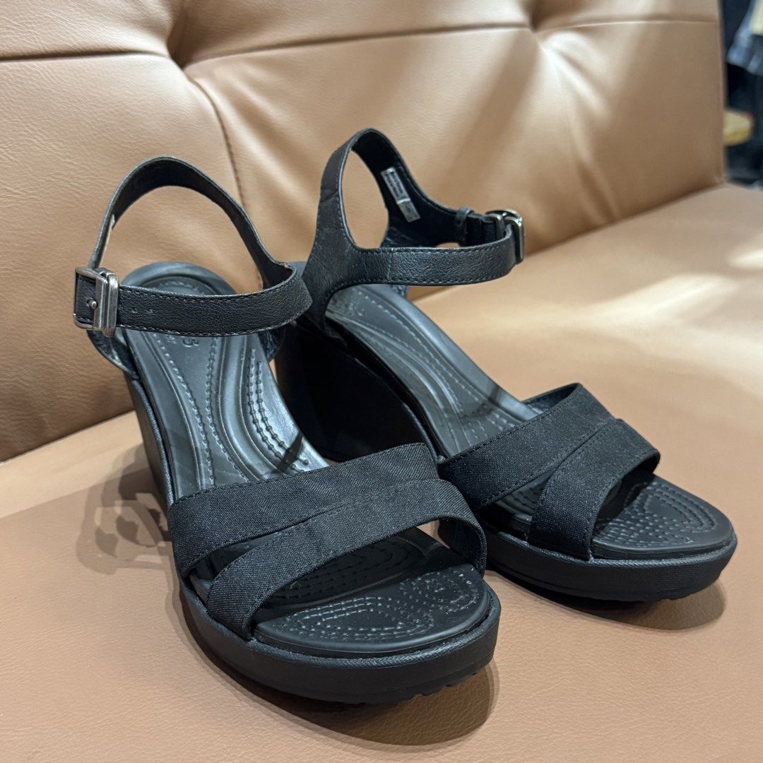 Original Crocs Black Wedge Sandals (Category: Wedges) located in Rizal. Submitted by houseofbell (Listing ID 1466504333, Image 1). Description: - Brand/Model: Crocs Wedge Sandals - Size: Women's W7 - Color: Black - Design: genuine leather strap with adjustable buckle ankle strap - Comfort: Dual Crocs comfort footbed for extra cushioning and support - Condition: Clean soles with great tread grip - Origin: Made in Vietnam -size 7.