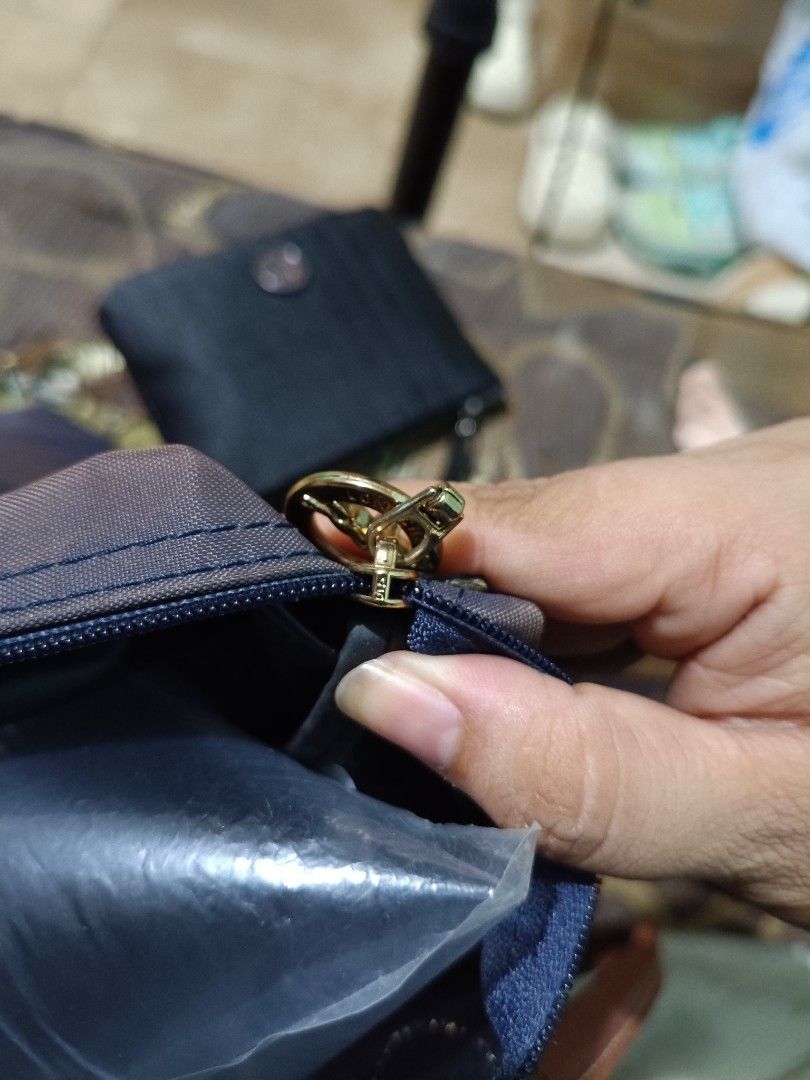 Original Longchamp Le Pliage Navy Blue Tote Bag (Category: Luxury Bags & Wallets) located in Manila. Submitted by rsnnpr24 (Listing ID 1466468284, Image 3). Description: - Authentic Longchamp Le Pliage shoulder bag (Made in France) - Color: Navy blue with brown leather handles and flap - Material: Durable foldable nylon body with gold-tone hardware - Closure: Zip top with iconic jockey medallion pull and snap button - Model details: Interior tag 