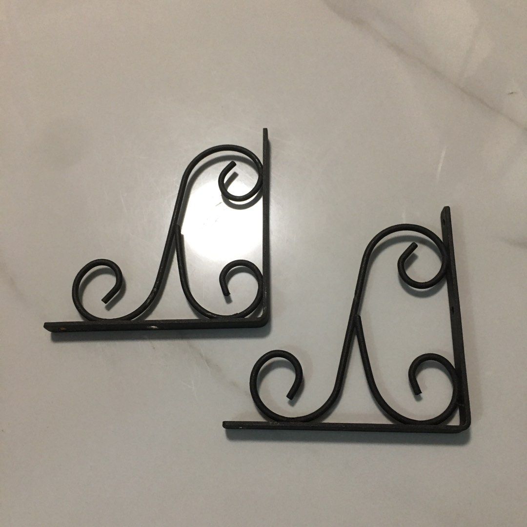 Pair of decorative black metal scroll shelf brackets (Category: Shelves, Cabinets & Racks) located in Pasay City. Submitted by gilbertso62551 (Listing ID 1466495367, Image 2). Description: - Set of 2 black metal shelf brackets - Vintage traditional style with ornate scrollwork / cast iron look - Sturdy and heavy-duty build for reliable support - Pre-drilled screw holes for quick and easy mounting - Ideal for floating shelves in the living room, k