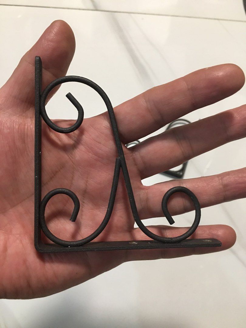 Pair of decorative black metal scroll shelf brackets (Category: Shelves, Cabinets & Racks) located in Pasay City. Submitted by gilbertso62551 (Listing ID 1466495367, Image 3). Description: - Set of 2 black metal shelf brackets - Vintage traditional style with ornate scrollwork / cast iron look - Sturdy and heavy-duty build for reliable support - Pre-drilled screw holes for quick and easy mounting - Ideal for floating shelves in the living room, k