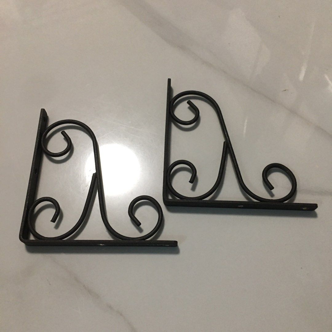 Pair of decorative black metal scroll shelf brackets (Category: Shelves, Cabinets & Racks) located in Pasay City. Submitted by gilbertso62551 (Listing ID 1466495367, Image 1). Description: - Set of 2 black metal shelf brackets - Vintage traditional style with ornate scrollwork / cast iron look - Sturdy and heavy-duty build for reliable support - Pre-drilled screw holes for quick and easy mounting - Ideal for floating shelves in the living room, k