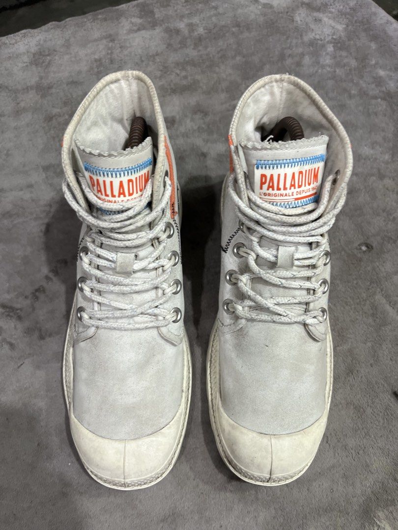 Palladium Pampa Underlayer High Top Trainers | Size 38 (Category: Boots) located in General Trias. Submitted by zrchustle.604 (Listing ID 1466443545, Image 2). Description: Palladium Pampa Underlayer High Top Trainers, featuring a distinct sand/beige colorway accented by bright orange detailing down the collar, exposed decorative stitching, and a side zipper closure. The Pampa Underlayer model updates Palladium's traditional canvas utility boot p