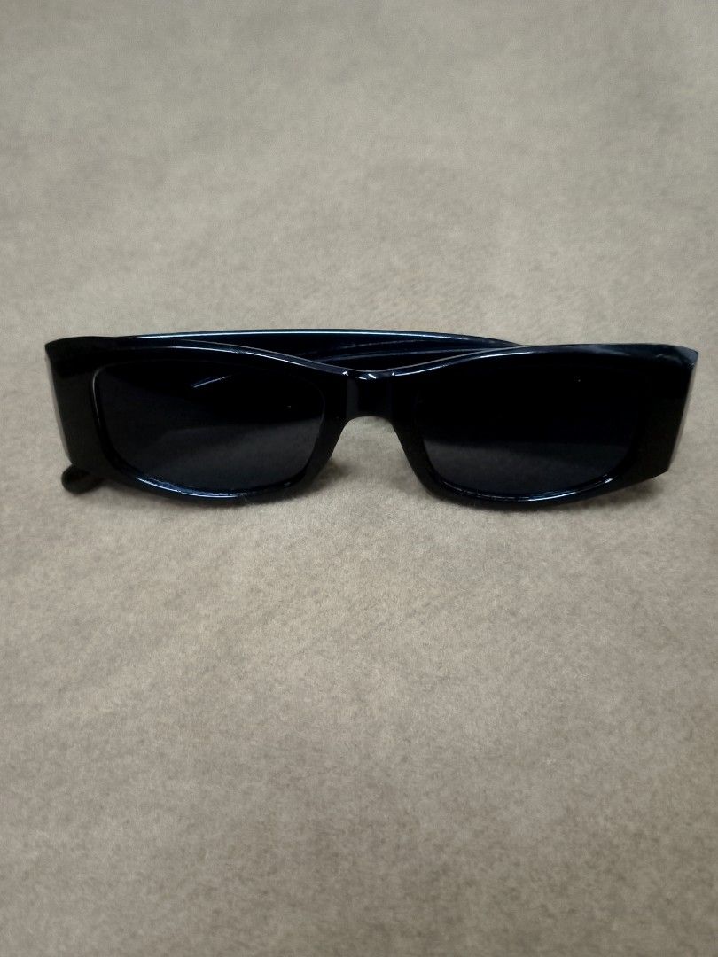 Palm Angels Black Rectangular Sunglasses (Category: Sunglasses & Eyewear) located in Aguinaldo. Submitted by ukayandthrift (Listing ID 1466413243, Image 3). Description: - Brand/Style: Black rectangular sunglasses with thick acetate frames - Details: Bold silver gothic Palm Angels lettering on both temples - Lenses: Dark tinted, zero scratches - Condition: Clean condition, flawless frame and lenses - Vibe: Ultimate accessory for a statement stree