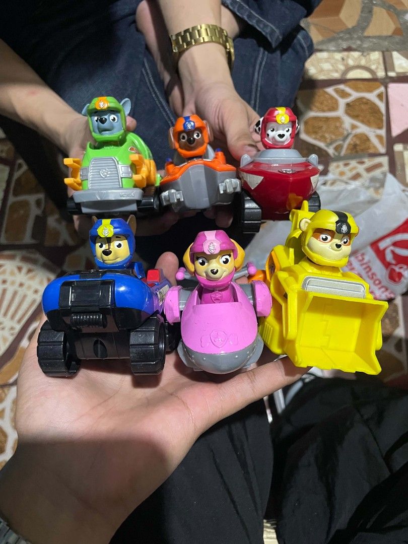 Paw Patrol Action Figures with Vehicles Set (Category: Action & Battle Toys) located in Manila. Submitted by mikeee03 (Listing ID 1466383190, Image 1). Description: - Complete set of 6 Paw Patrol figures and rescue vehicles: Chase, Marshall, Rubble, Rocky, Zuma, and Skye - Includes bonus interchangeable pirate hats for Marshall and Skye - Clean and well-maintained condition - Sold as a complete set only - Perfect gift for young Paw Patrol fans.
