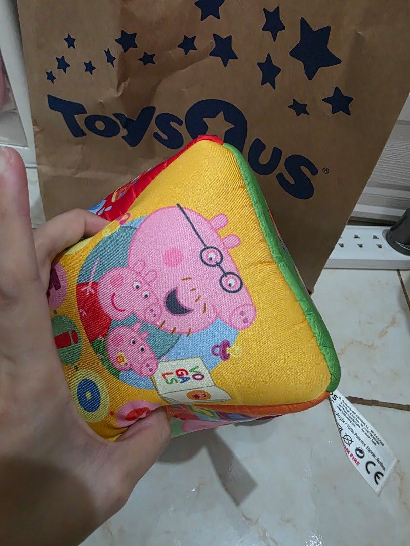 Peppa Pig Soft Activity Cube Sensory Toy (Category: Infant Playtime) located in Taguig. Submitted by jeaniper (Listing ID 1466362696, Image 2). Description: - Official Peppa Pig sensory activity cube for babies and toddlers - Features bright illustrations of Peppa, George, and family - Multi-colored panels with interactive elements, numbers, and characters - Includes a fun mirror flap and various textured tabs for sensory play - Made of soft fabr