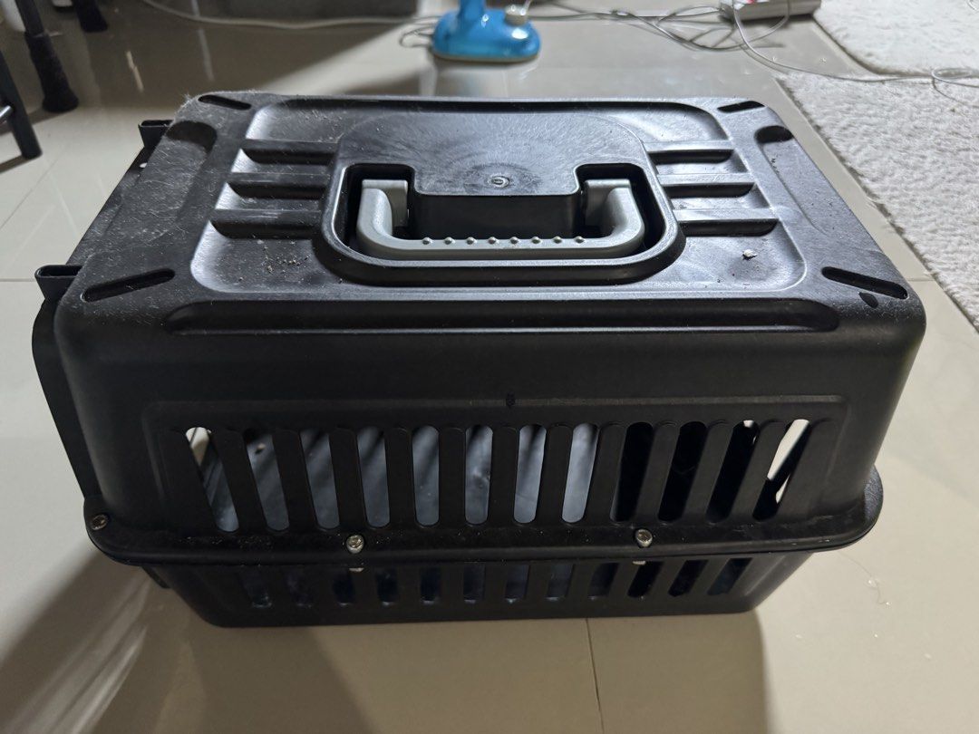 pet carrier (Category: Health & Grooming) located in Cagayan de Oro. Submitted by serenexsienna (Listing ID 1466528541, Image 1). Description: ✅Black Plastic Small Pet Carrier with Handle ✅Type: Black plastic carrier suitable for cats and small dogs ✅Comfort & Safety: Vented slots all around for airflow and secure side screws ✅Portability: Sturdy top handle for easy carrying ✅Condition: Used with some dust on top, fully functional ✅meet-up ✅deliv